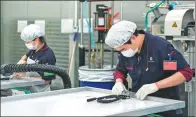  ?? SHEN HONG / XINHUA ?? A junction box is assembled at a Sino-German plant in Hangzhou, Zhejiang province, in April. More than 50 percent of the plant’s products are sold overseas.