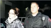  ?? Calgary Herald/files ?? Sheena Cuthill, shown being taken into custody, was the only one of the accused to appear in court in person.