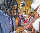  ?? AP PHOTO/BUTCH DILL ?? Alabama wide receiver Jerry Jeudy signs autographs Wednesday during SEC Media Days in Hoover, Ala. Jeudy said his approach to the Crimson Tide’s lopsided loss to Clemson in the national championsh­ip game in January has been “So what? Now what?”