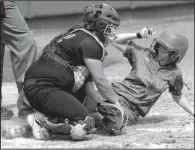  ?? NWA Democrat-Gazette/ANDY SHUPE ?? North Little Rock catcher Makenzie Escovedo (left) tries to tag Cabot’s Macee Abbott at the plate during the third inning Friday. The Lady Panthers scored their first run in the inning after two walks, a single and a hit batter.