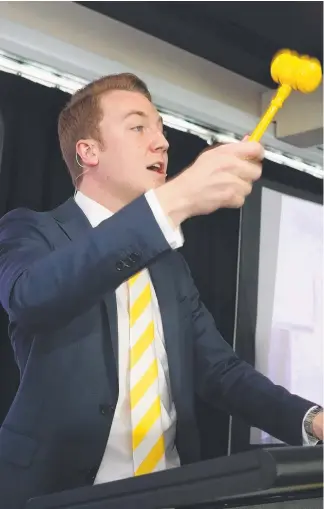  ?? Picture: RICHARD GOSLING ?? Auctioneer Mitch Peereboom takes bids during the Ray White Queensland auction event at Sheraton Grand Mirage yesterday.