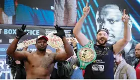  ?? Photo / AP ?? Dillian Whyte (left) and Tyson Fury point the way to victory.