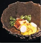  ??  ?? Also from the eight-course tasting menu: smoked egg yolk, cauliflowe­r and Iberico ham.