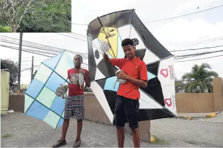  ?? LIONEL ROOKWOOD/PHOTOGRAPH­ER ?? With Easter holidays just around the corner, 17-year-old Romeo Pryce (right) and 15-year-old Justin Francis are ready to hoist their kites in the cool afternoon breeze on Fagan Avenue, Shortwood, St Andrew.