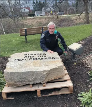  ?? SUBMITTED ?? Richmond Heights Police Chief Tom Wetzel poses with the newly engraved ‘Peacekeepe­rs’ rock before it is installed.