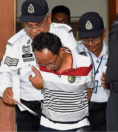  ??  ?? A day in court: Police officers escorting Anuar to the magistrate’s court in Kuala Selangor where he was charged with dangerous driving and causing an accident at the Kuala Lumpur-Kuala Selangor (Latar) highway.