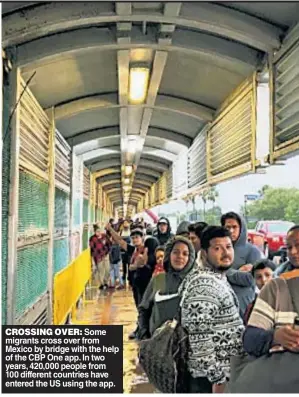  ?? ?? CROSSING OVER: Some migrants cross over from Mexico by bridge with the help of the CBP One app. In two years, 420,000 people from 100 different countries have entered the US using the app.