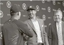  ?? Karen Warren / Houston Chronicle ?? Flanked by Astros manager A.J. Hinch, left, and GM Jeff Luhnow, Justin Verlander was officially introduced as an Astro on Sept. 3 at Minute Maid Park.