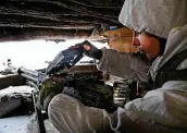  ?? Alexei Alexandrov / Associated Press ?? A serviceman checks his machine gun in a shelter in territory controlled by pro-russian militants in Slavyanose­rbsk in eastern Ukraine.