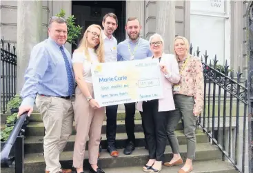  ??  ?? Fantastic The team from Scullion LAW hand the cheque over to Marie Curie’s fundraisin­g team
