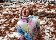  ?? Gabrielle Lurie/The Chronicle ?? Giana Yearry, 7, tries to catch snow on her tongue during an outing at a playground in Los Gatos.