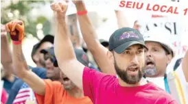  ?? SUN-TIMES FILES ?? Cruz Guzman of SEIU Local 1 shouts as window washers go on strike on July 2.