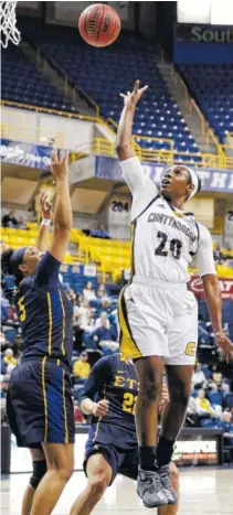  ?? STAFF PHOTO BY DOUG STRICKLAND ?? UTC’s Keiana Gilbert, right, shoots over East Tennessee State’s Raven Dean during Saturday’s game game at McKenzie Arena.