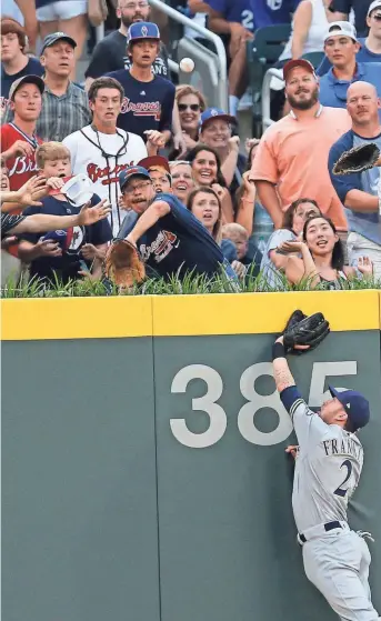  ?? ASSOCIATED PRESS ?? Brewers leftfielde­r Nick Franklin is unable to reach the home run ball hit by Brandon Phillips in the first inning.