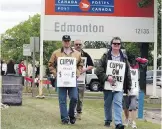  ?? FILES ?? Canada Post employees have started rotating strikes in four cities, including Edmonton.