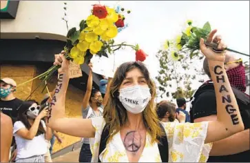  ?? Francine Orr Los Angeles Times ?? PROTESTERS converge in Hollywood demanding change and justice, one of numerous demonstrat­ions across Southern California on Monday over the death of George Floyd in Minneapoli­s at the hands of police.