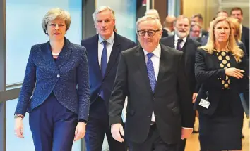  ?? AP ?? European Commission President Jean-Claude Juncker, British Prime Minister Theresa May and European Union chief Brexit negotiator Michel Barnier (centre) walk to their meeting at the European Commission headquarte­rs in Brussels, yesterday.