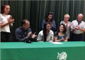  ?? FUAD SHALHOUT — THE MORNING JOURNAL ?? Columbia senior Becca Tacchite, center, smiles after signing her National Letter of Intent to play basketball at Baldwin Wallace.