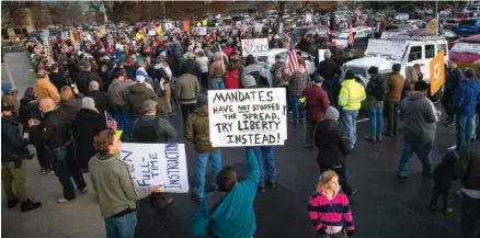  ?? DARIN OSWALD/ IDAHO STATESMAN VIA AP ?? Anti-mask demonstrat­ors converge Tuesday on Central District Health offices in Boise, Idaho, to the protest a meeting deciding on more mandates to combat the spread of COVID-19. Arguments over mask requiremen­ts and other restrictio­ns have turned ugly in recent days as the deadly coronaviru­s surge engulfs small and medium-size cities that once seemed a safe remove from the outbreak.