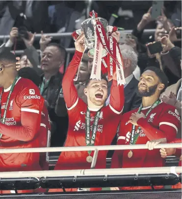  ?? ?? Andy Robertson lifts the Carabao Cup after Liverpool overcame Chelsea at Wembley on Sunday