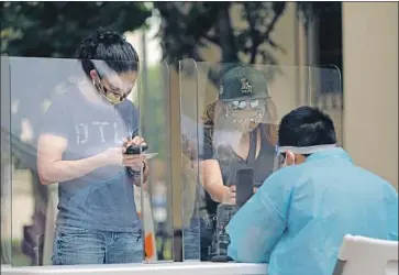  ?? Myung J. Chun Los Angeles Times ?? THE RATE of California­ns testing positive for the coronaviru­s continues to fall as the state reduces the turnaround time for tests. Above, people sign up at a Union Station kiosk capable of conducting 500 tests a day.