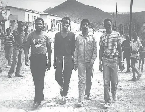  ?? Picture: Tiso Blackstar Group ?? BRIEF RESPITE Fort Calata, second from right, and Matthew Goniwe, far right, two of the Cradock Four who were murdered by security police in 1985, are accompanie­d home by two activists after being released from detention in 1984.