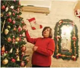  ??  ?? Hanadi Missak, a 48-year-old Christian woman, adjusts the ornaments on her Christmas tree during an interview in her house in Gaza City on Dec 22, 2019.