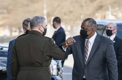  ?? Getty images ?? FIRST DAY: Defense Secretary Lloyd Austin III, right, is greeted by Mark Milley, chairman of the Joint Chiefs of Staff, as he arrives at the Pentagon for his first day on the job.