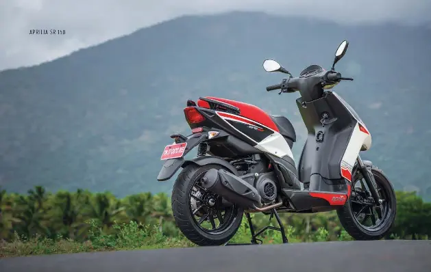  ??  ?? Main: The rear gets motorcycle design cues like the split grab handles, tyre hugger and upswept exhaust can. Below: Front apron gets a simple luggage hook. Aprilia keys equate immense bragging rights