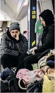  ?? ARIS MESSINIS AFP ?? A COUPLE sit in an undergroun­d metro station, which is being used as bomb shelter, in the Ukrainian capital Kyiv on Wednesday.
|