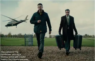  ?? ?? Theo James in “The Gentlemen” wearing a
Barbour jacket with a butler holding Carl Friedrik suitcases.