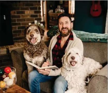  ?? PHOTO COURTESY AMANDA STEFFKE/AMANDA STEFFKE PHOTOGRAPH­Y ?? Dominic Thrasher, author of the children’s book, “The Adventures of Cece and the Sheriff,” poses with the Aussiedood­les who inspired the book.