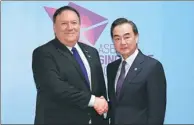  ?? MOHD RASFAN / REUTERS ?? Foreign Minister Wang Yi (right) and US Secretary of State Mike Pompeo meet on the sidelines of the annual ASEAN Foreign Ministers’ Meeting in Singapore on Friday.