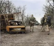  ?? Ap ?? CHECKPOINT: Members of a pro-Russian militia patrol a road outside Mariupol, Ukraine.