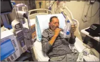  ?? FRANCINE ORR/ LOS ANGELES TIMES/TNS ?? COVID-positive patient Jorge Hernandez, 64, does his lung exercise with his incentive spirometer in the COVID unit inside Little Company of Mary Medical Center on July 30 in Torrance.