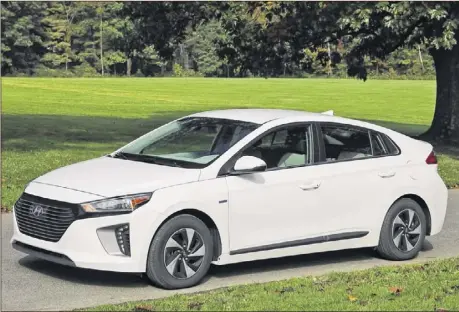  ??  ?? THE IONIQ is Hyundai’s compact, five-door liftback, now available in hybrid, plug-in hybrid and all-electric versions. Along with an electric motor, the SEL hybrid (above) gets its power from a 1.6L Atkinson cycle four-cylinder (left).