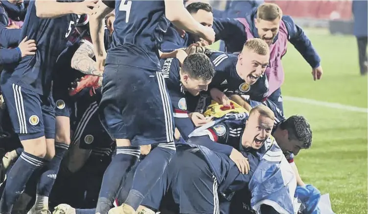  ??  ?? 0 The Scotland players enjoy a pile-up in Belgrade following last night’s penalty shootout victory against Serbia