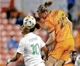  ?? Michael Wyke / Associated Press ?? Dynamo midfielder Griffin Dorsey, right, jumps to head the ball over Austin FC forward Cecilio Dominguez. Dorsey scored the game’s first goal in 48 seconds.