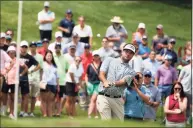  ?? John Minchillo / Associated Press ?? Bubba Watson hits onto the first green during the third round of the Travelers Championsh­ip on Saturday.