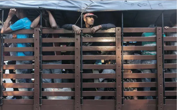  ??  ?? Venezuelan­s without valid visas are detained in a truck by the Colombian police in Cucuta. As many as 100 migrants are being sent back every day.