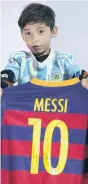  ??  ?? Ordeal: Murtaza Ahmadi (7) with a Barcelona shirt signed by his footballin­g hero Lionel Messi