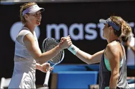  ?? VINCENT THIAN / ASSOCIATED PRESS ?? Maria Sharapova (left) shakes hands with Tatjana Maria on Tuesday after their firstround match, which Sharapova won 6-1, 6-4.