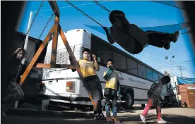  ??  ?? Children play after class in the converted bus in Tijuana.