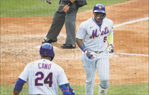  ?? Seth Wenig / Associated Press ?? New York Mets’ Yoenis Cespedes, right, celebrates his solo home run during the seventh inning of the game against the Atlanta Braves at Citi Field on Friday in New York.