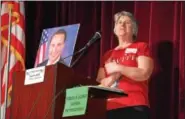  ?? DIGITAL FIRST MEDIA FILE PHOTO ?? Tammy Harkness, an organizer of the Feb. 25town hall meeting at Phoenixvil­le High School, stands next to a photo of Congressma­n Ryan Costello, who was invited to the meeting but could not attend because of scheduling conflicts. Costello now says in...