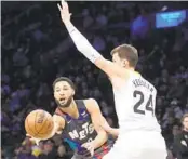  ?? MARY ALTAFFER AP ?? Nets guard Ben Simmons moves the ball around Jazz center Walker Kessler during the first half Monday.