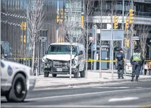  ?? CP PHOTO ?? Police are seen near a damaged van in Toronto after a van mounted a sidewalk crashing into a number of pedestrian­s Monday. Monday’s deadly rental van rampage in Toronto shows how quickly a vehicle can be turned into a weapon.