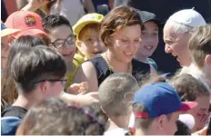  ?? — AFP ?? Pope Francis greets people during a visit to the Roman Parish of San Pier Damiani.