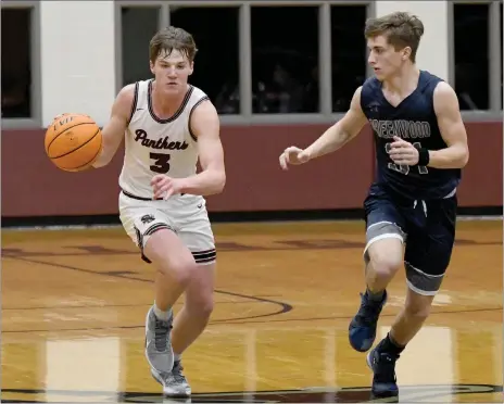  ?? Bud Sullins/Special to the Herald-Leader ?? Siloam Springs junior Josh Stewart brings the ball up the floor as Greenwood’s Chase Beshears defends Monday in the 5A-West Conference Tournament quarterfin­als inside Panther Activity Center. Stewart scored 20 points as the Panthers defeated the Bulldogs 61-40 to clinch a spot in the Class 5A state tournament.