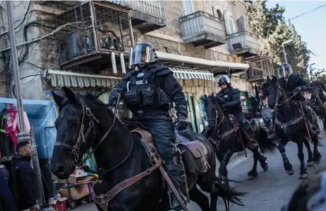  ?? CHRIS MCGRATH/GETTY IMAGES ?? Mounted Israeli police officers clear a street of protesters outside the Damascus Gate of the Old City after Friday prayers in Jerusalem.